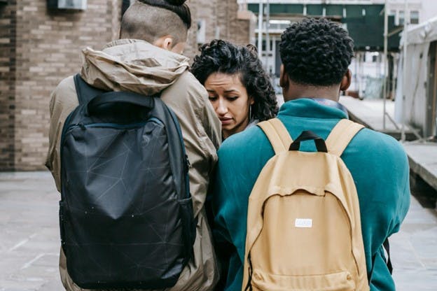 Young men bullying a woman