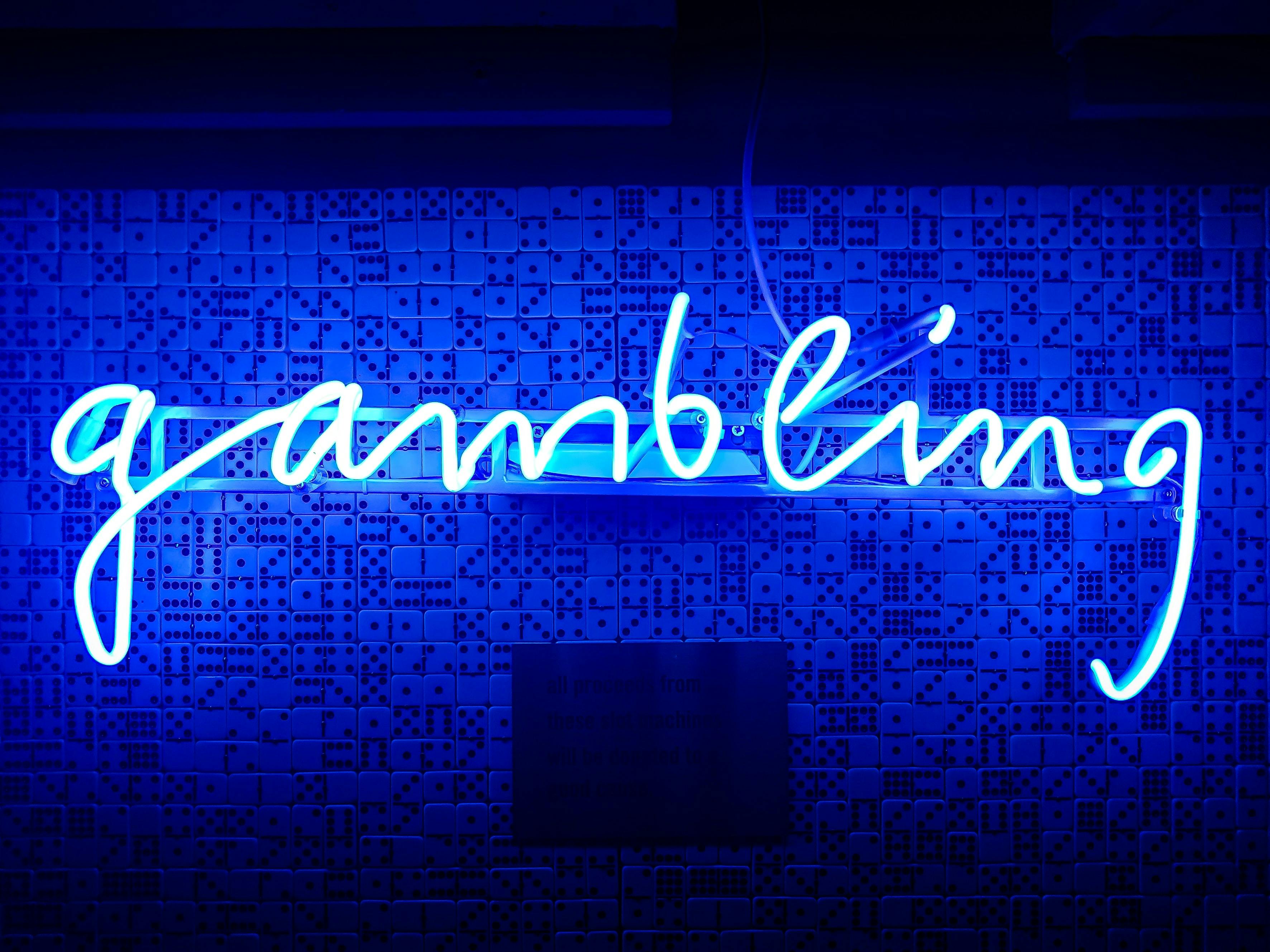 gambling neon sign - Photo by Stéphane Mingot on Unsplash