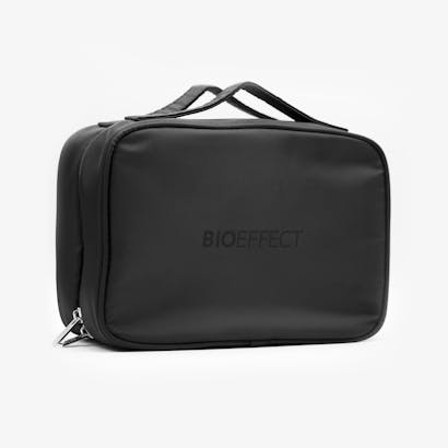 The BIOEFFECT branded black travel bag placed on a white surface.
