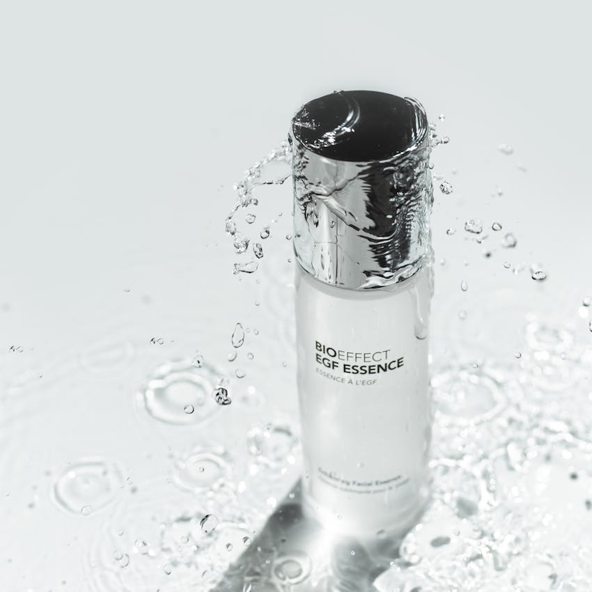 Bottle of BIOEFFECT EGF Skincare Hydrating Essence standing up underneath clear water.