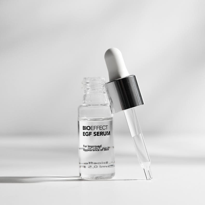 A bottle of BIOEFFECT EGF serum with the dropper removed and leaning against the bottle.
