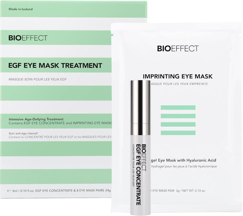 Green-and-white striped square-shaped package of BIOEFFECT Anti Aging Skincare EGF Hydrating Eye Mask Treatment. A small white Imprinting Eye Mask package and an EGF Eye Concentrate roller bottle sit towards the right center.