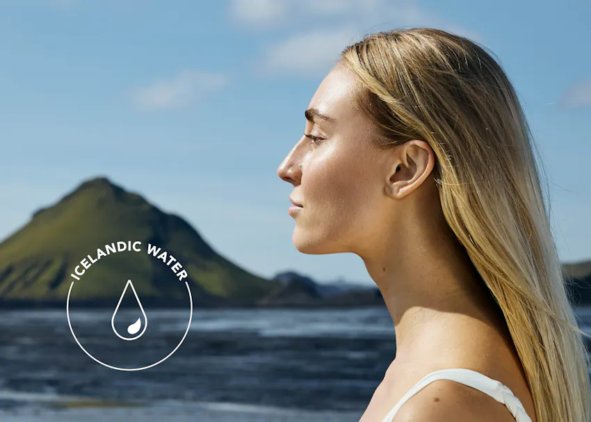 Model standing before an Icelandic landscape, emphasizing the pure Icelandic water used in BIOEFFECT EGF Essence and the brand’s connection to Icelandic nature