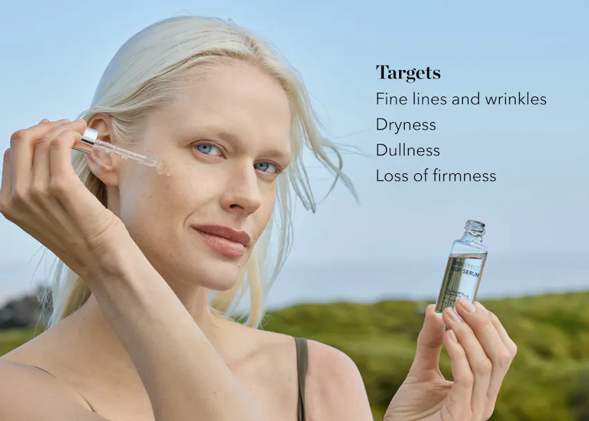Woman applying BIOEFFECT EGF Serum with dropper, targeting fine lines, dryness, dullness, and loss of firmness