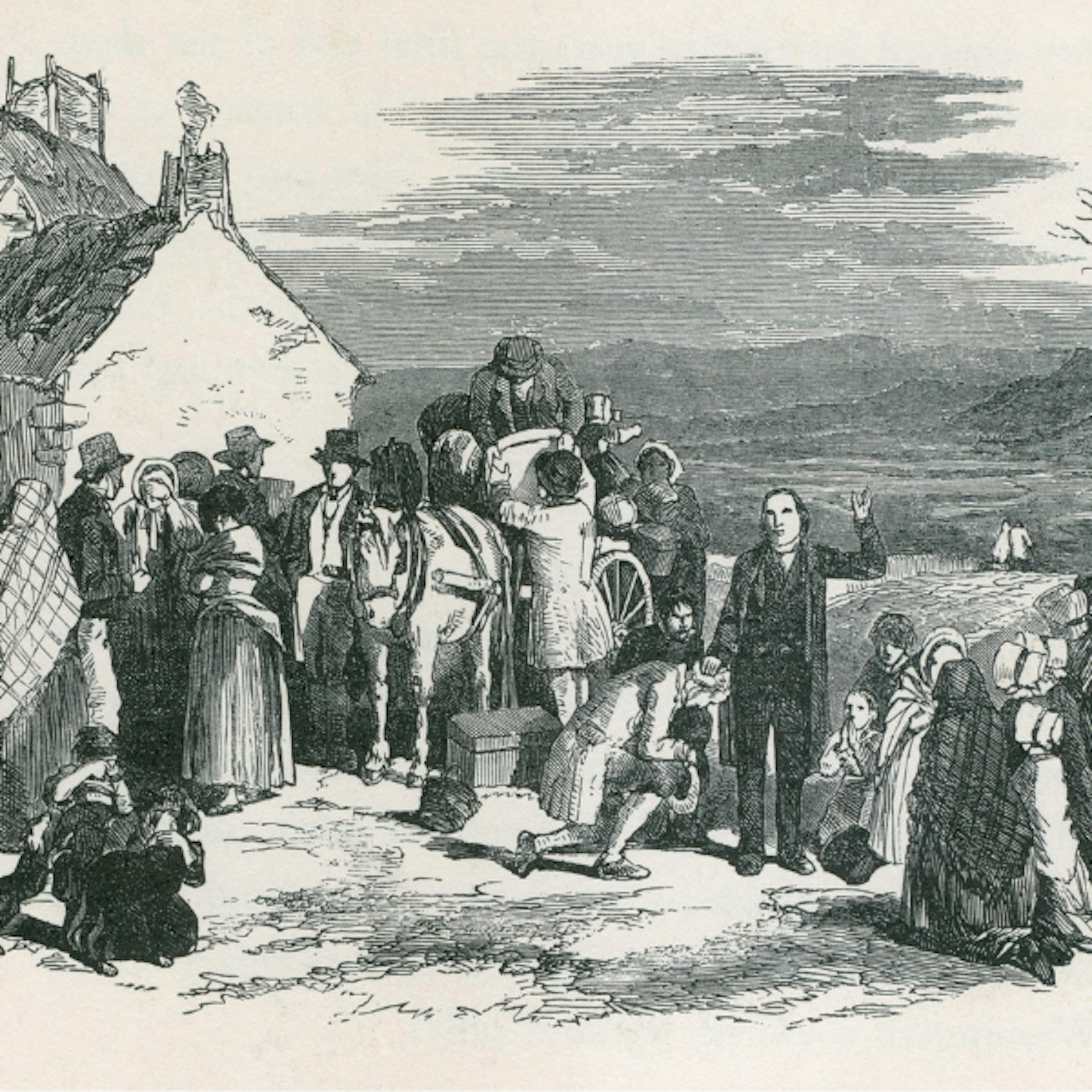 Catholic priest blesses kneeling immigrants leaving Ireland
