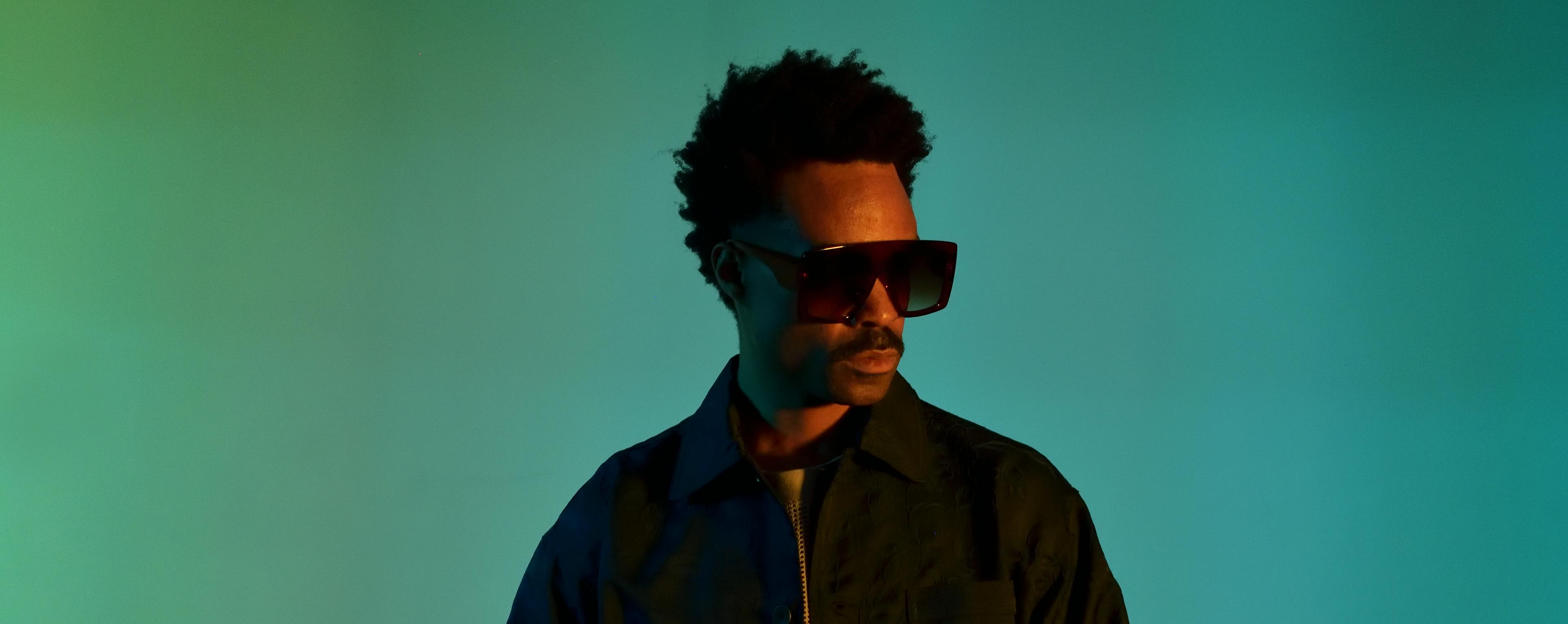 Artist Bilal, wearing sunglasses and a black shirt