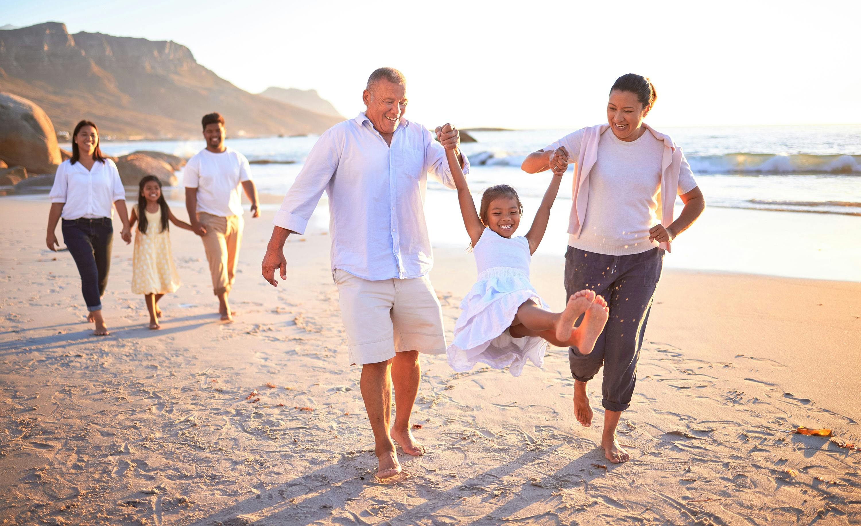 Families on beach representing connections that hearing care supports