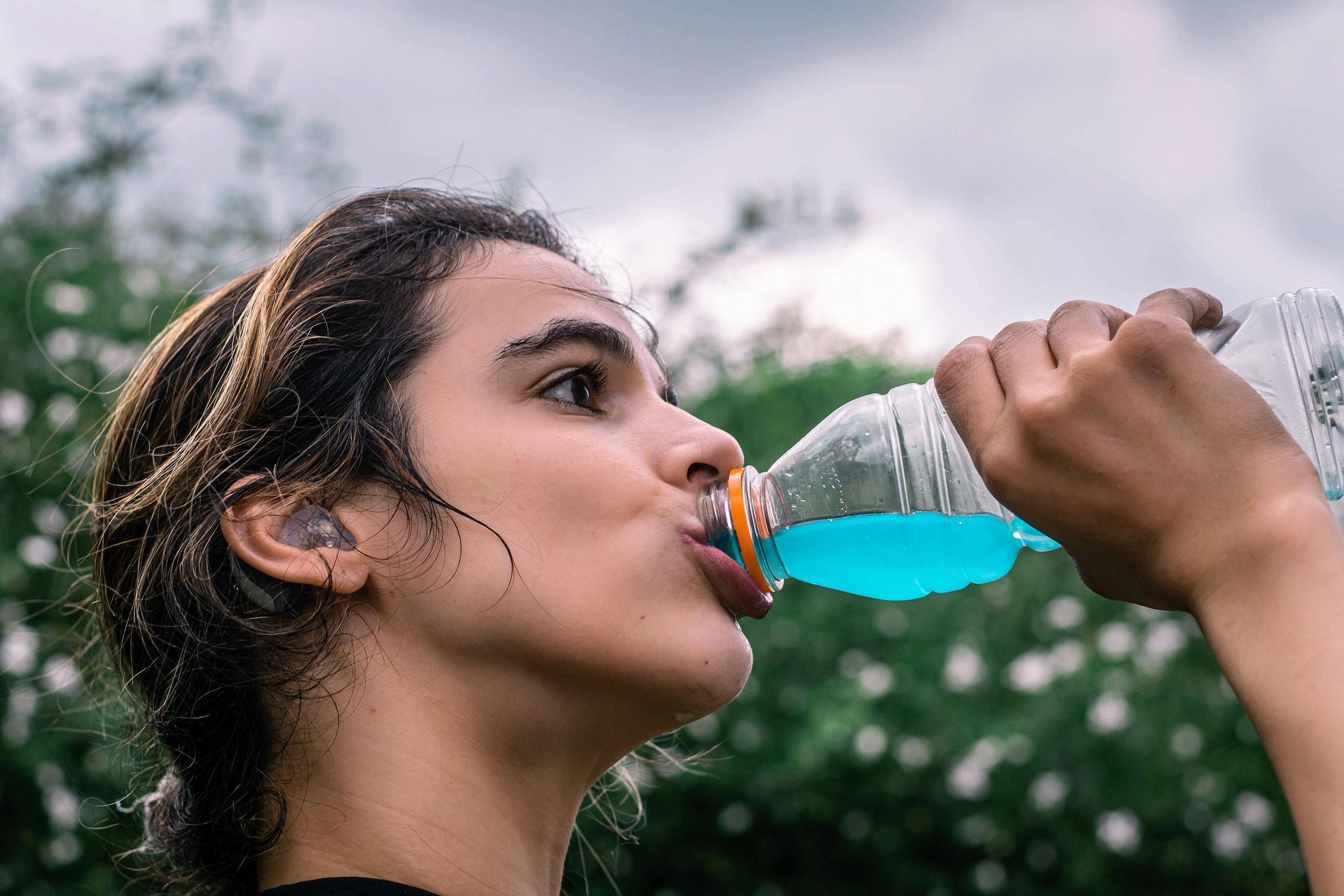 Health and wellness represented by woman drinking energy drink