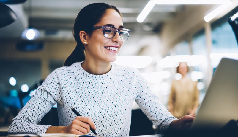Woman smiling at desk while working