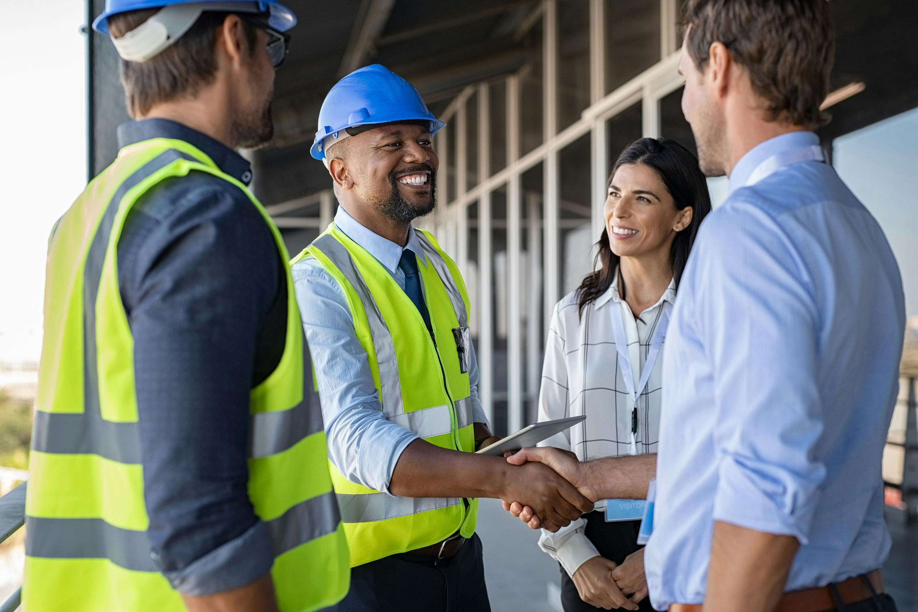 improved workplace safety with hearing insurance represented by construction workers shaking hands