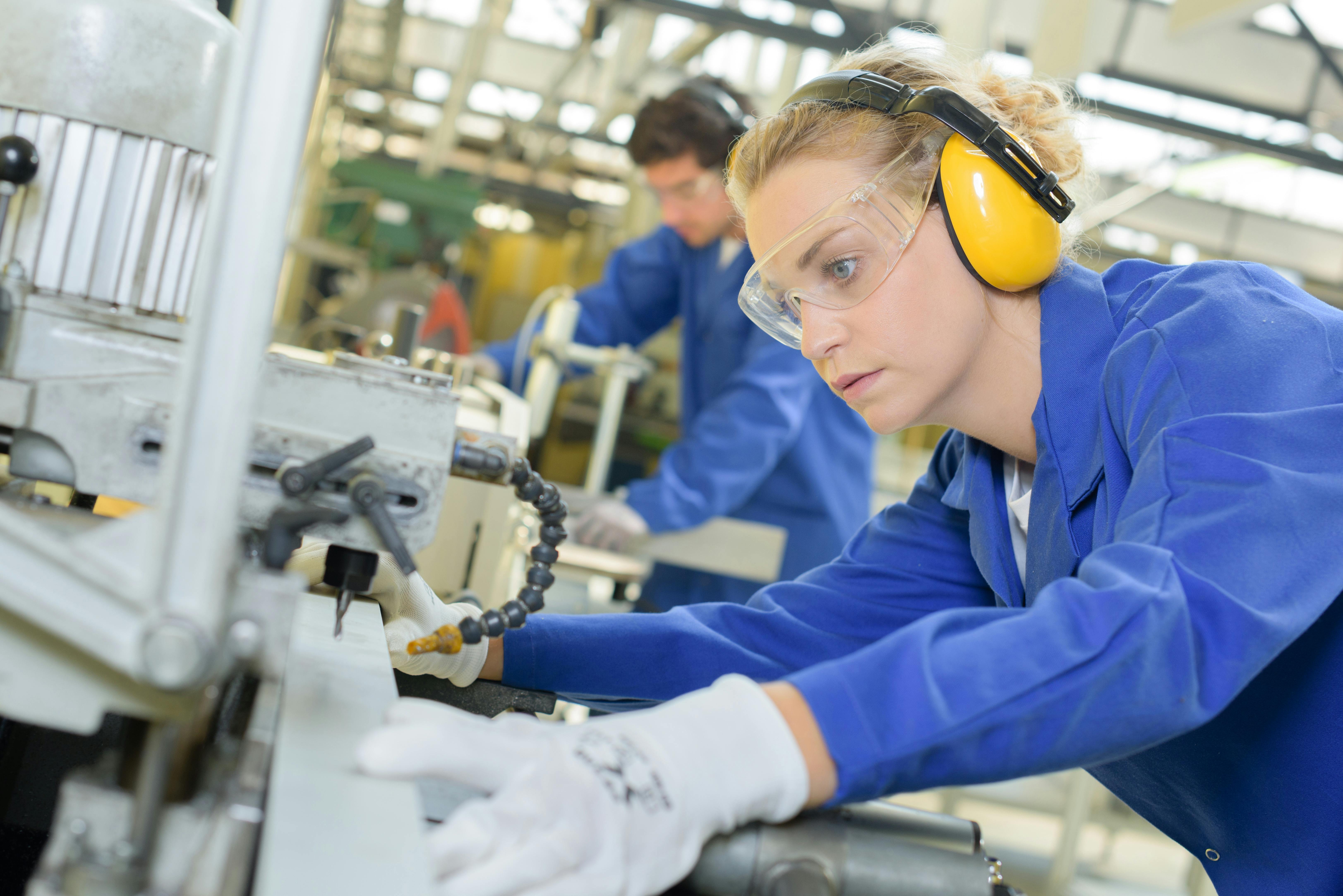 Improved workplace safety with hearing benefits represented by people working with machinery