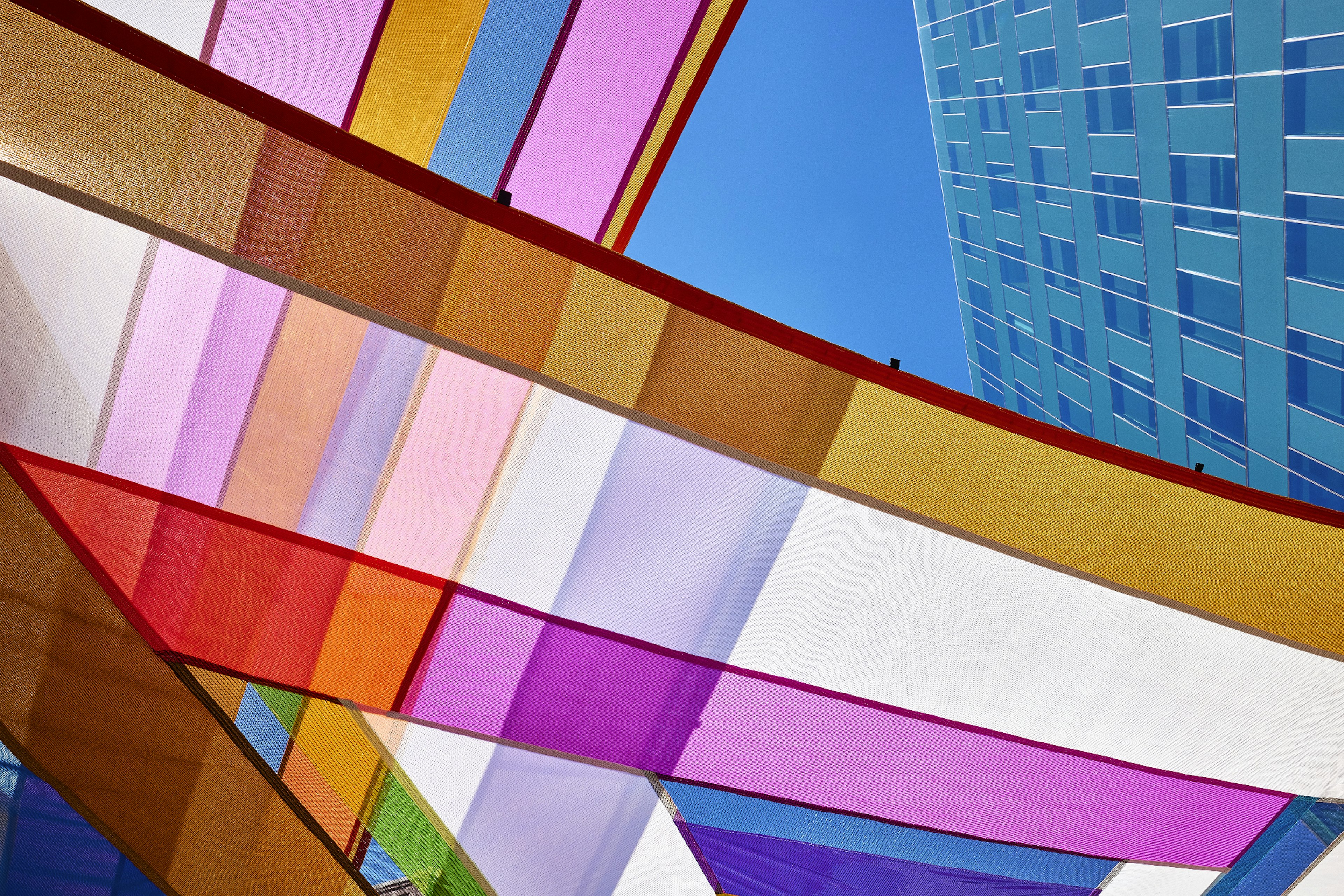 Rachel Hayes, Horizon Drift, 2024. Plaza of the Americas, Denver, Colorado. Site-specific installation composed of various industrial textiles, vinyl, and thread. Presented by the Biennial of the Americas with artistic direction by Black Cube Nomadic Art Museum. Courtesy the artist and Black Cube. Photo: Third Dune Productions.