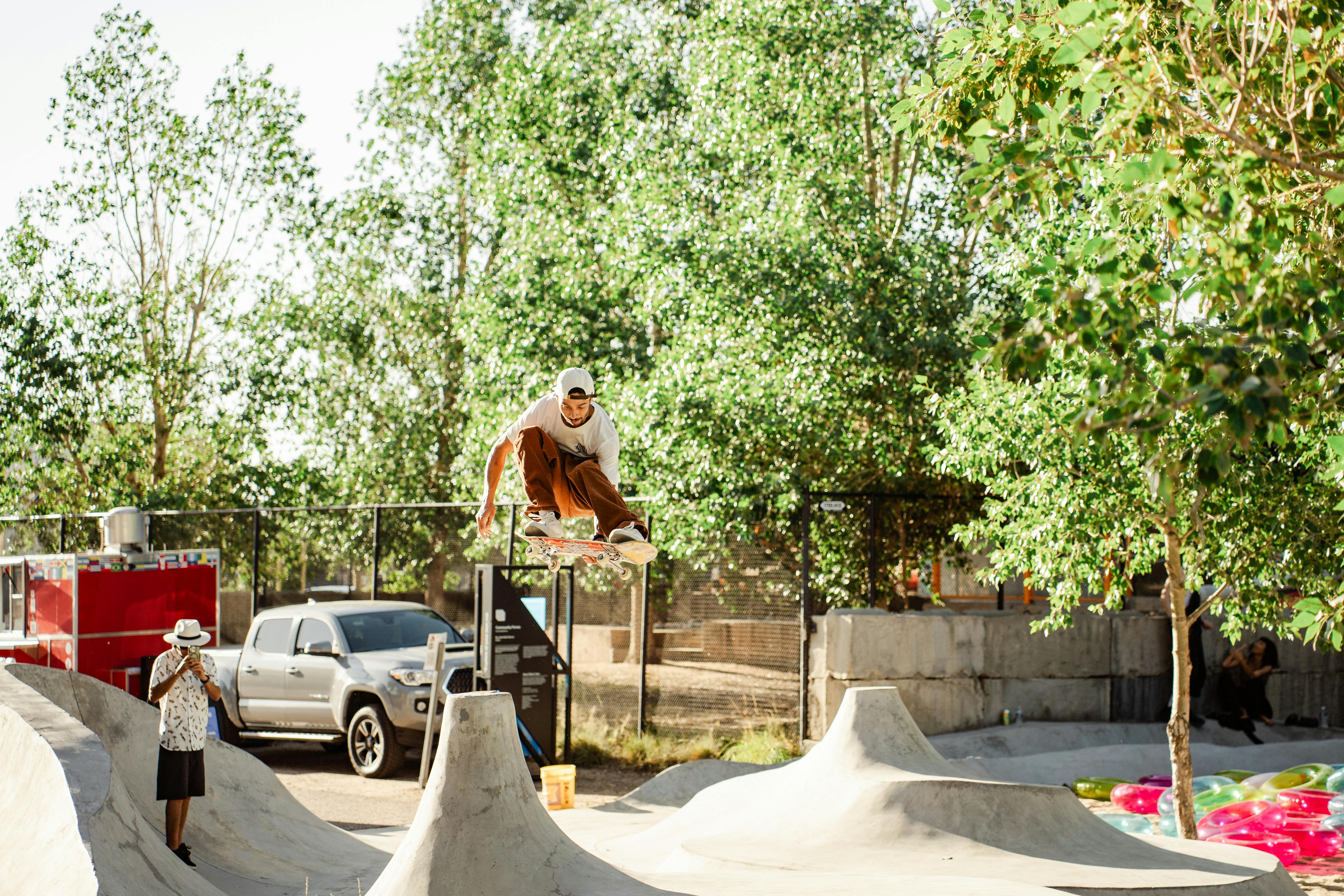 Julian Christianson skateboarding on Matt Barton, "Community Forms," 2021, concrete, formed earth, and landscaping materials. TAXI Campus in Denver, Colorado. Courtesy of the artists and Black Cube Nomadic Art Museum. Photo by From the Hip Photo.