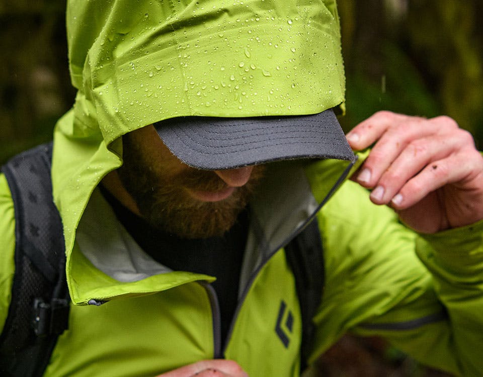 man zipping up his jacket