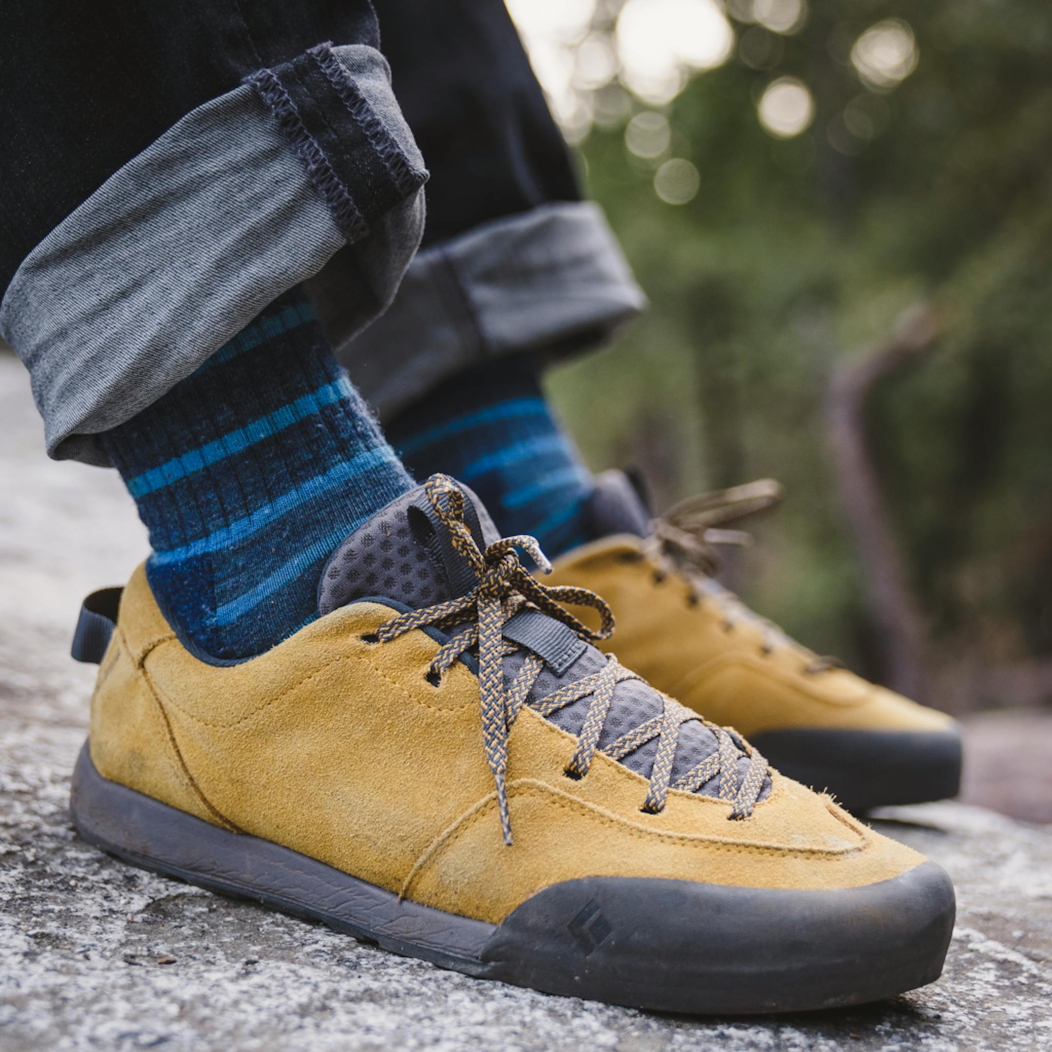 Front detail shot of Men's Prime Shoes in colorway Amber/Carbon on a boulder