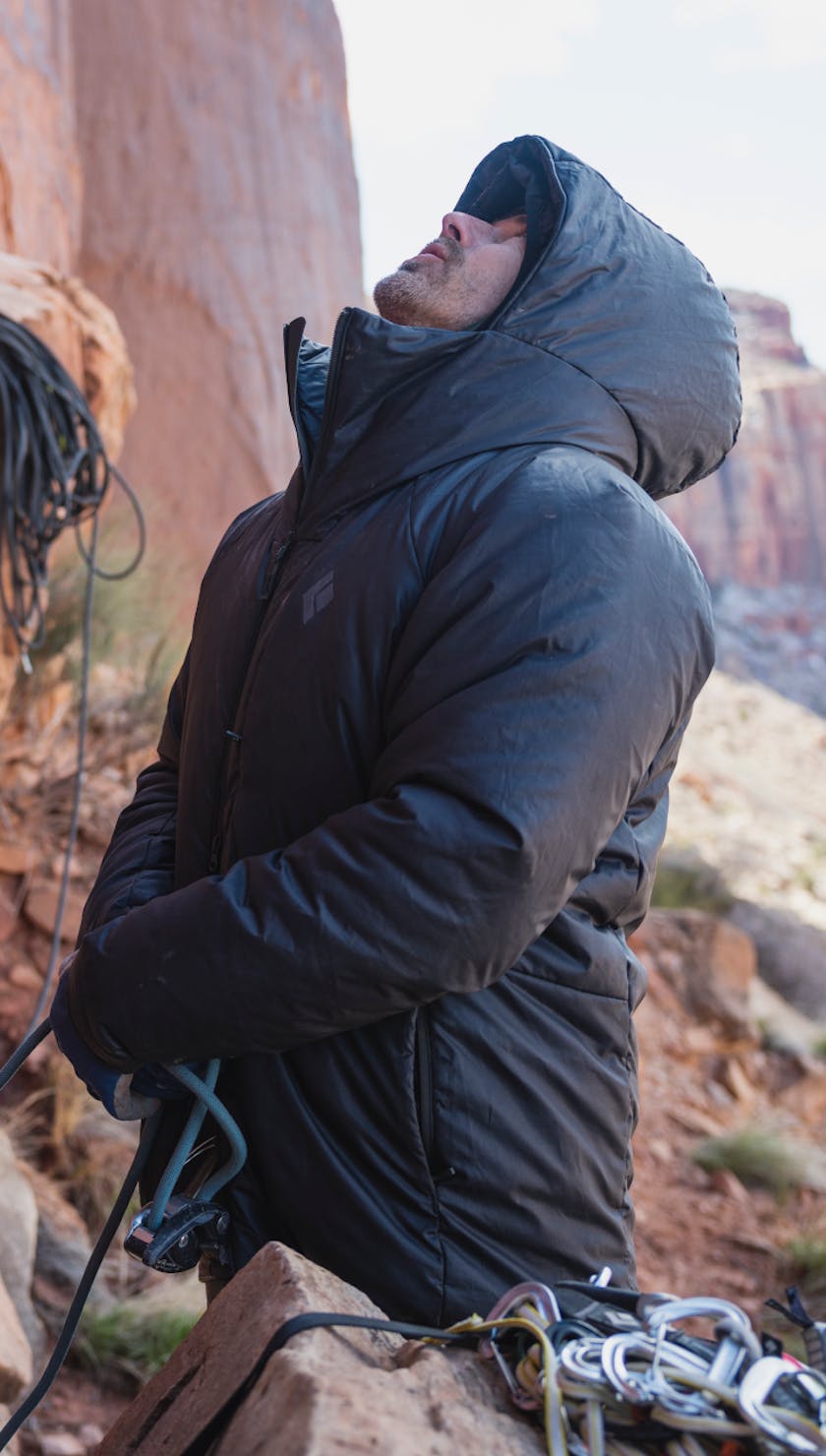 The Belay Parka. A climber belays their partner in the Black Diamond Belay parka.