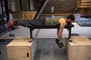 Sam Elias performing reverse dumbbell fly