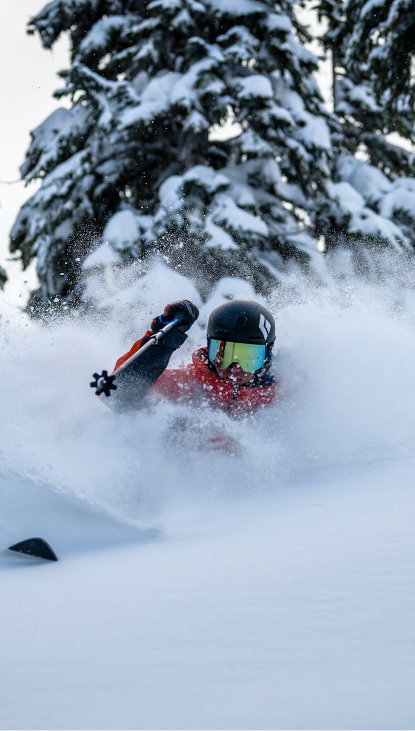 Black Diamond athlete Tobin Seagel backcountry skiing in deep powder on the Helio Carbon Skis.