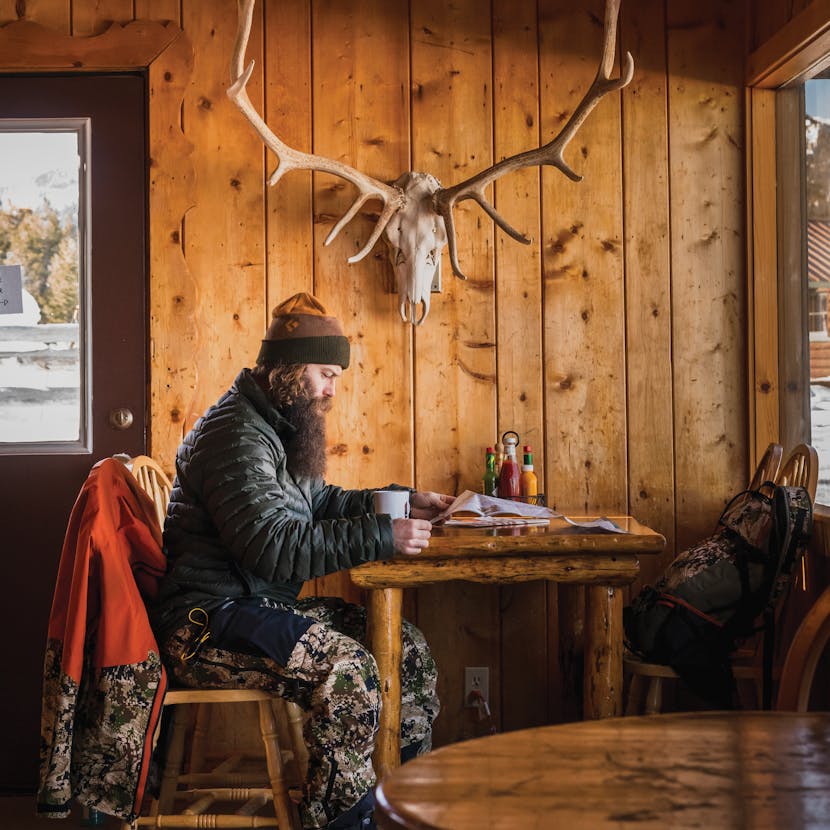 Black Diamond athlete Eric Jackson reads the backcountry report in the cabin.