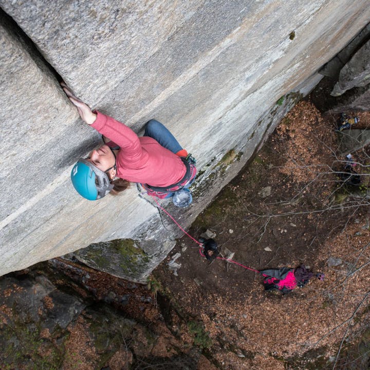 Photo by Andy Earl of Woman climbing a crack | Women's Base Layer Tops