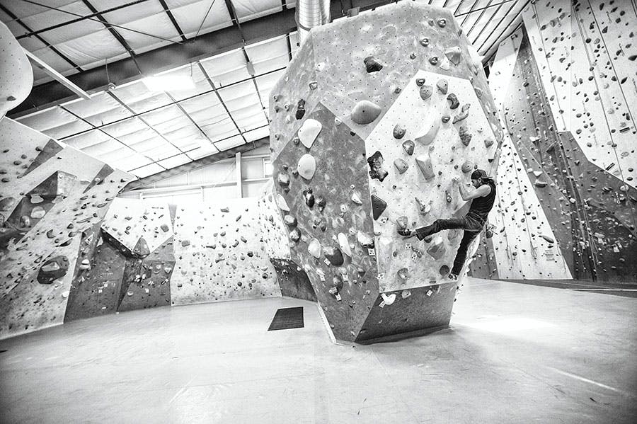Sam Elias bouldering in a gym