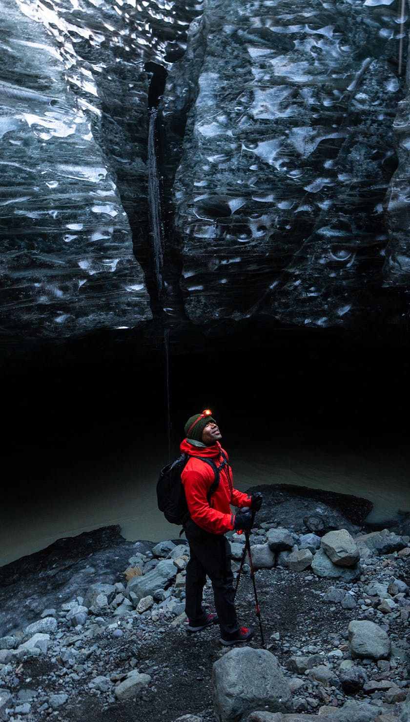Black Diamond Ambassador Andre King stands in an ice cave wearing the Highline Stretch shell and pant. 