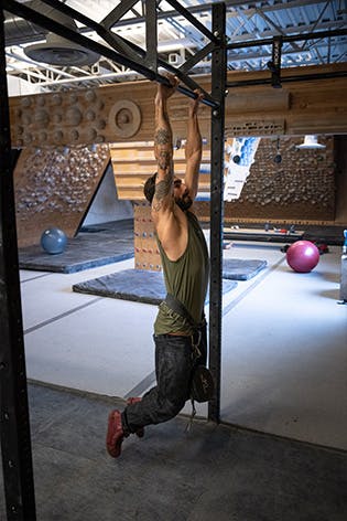 Sam Elias performing a weighted pull-up