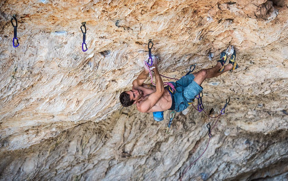 Photo of Joey Kinder rock climbing.