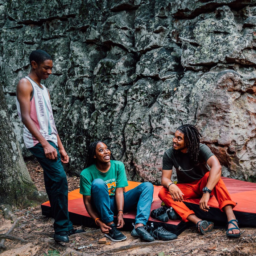 HBCUs Outside relaxing at a bouldering problem.