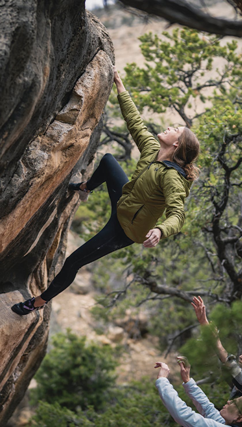 The Bouldering Kit. A climber shakes out before topping out on a boulder problem.