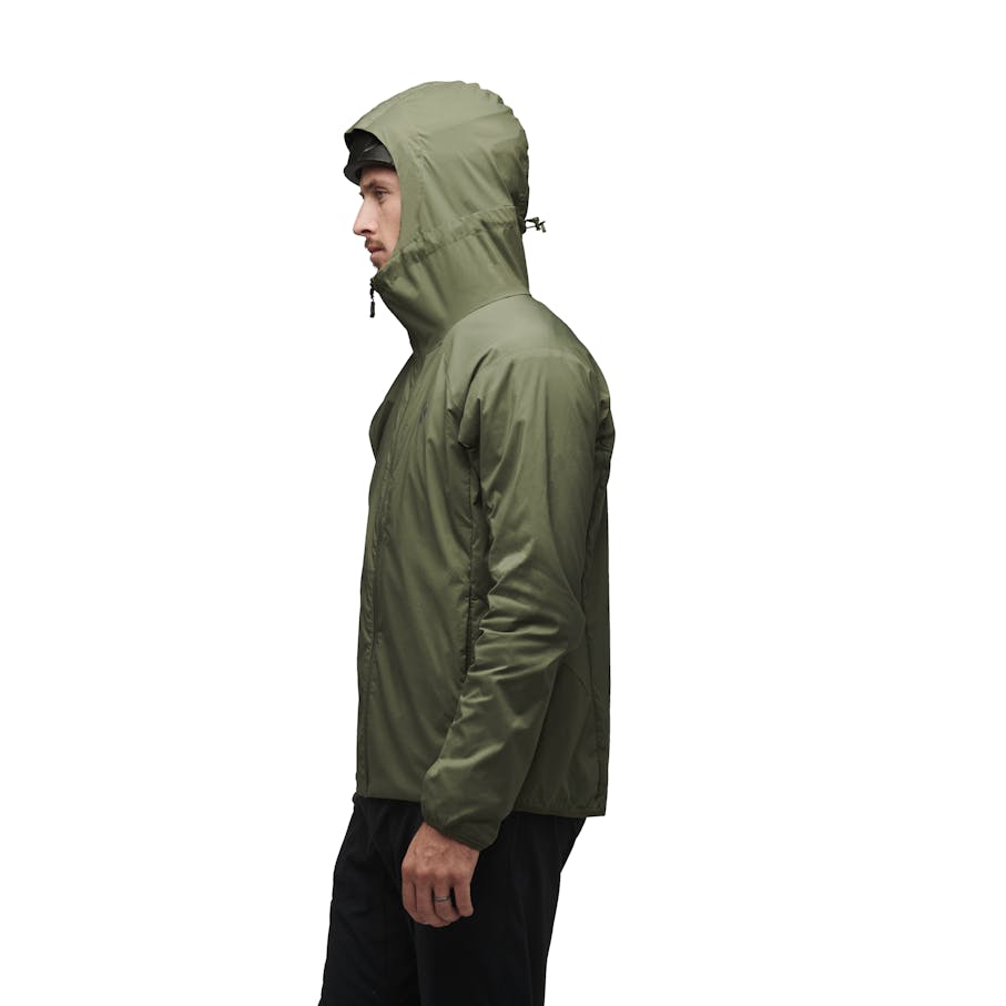 A side view of a model wearing the Alpine Start Insulated Hoody.