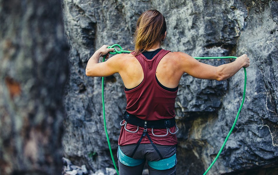 climber preparing her rope for a climb