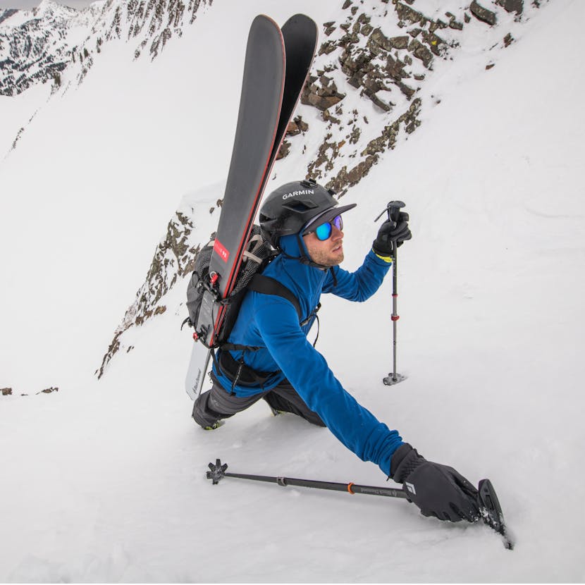 A Skier boot backs up a mountain wearing the Black Diamond Coefficient Hoody.  