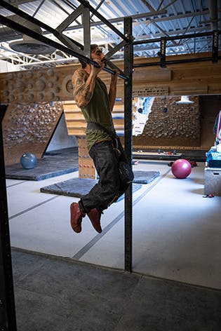 Sam Elias performing a weighted pull-up