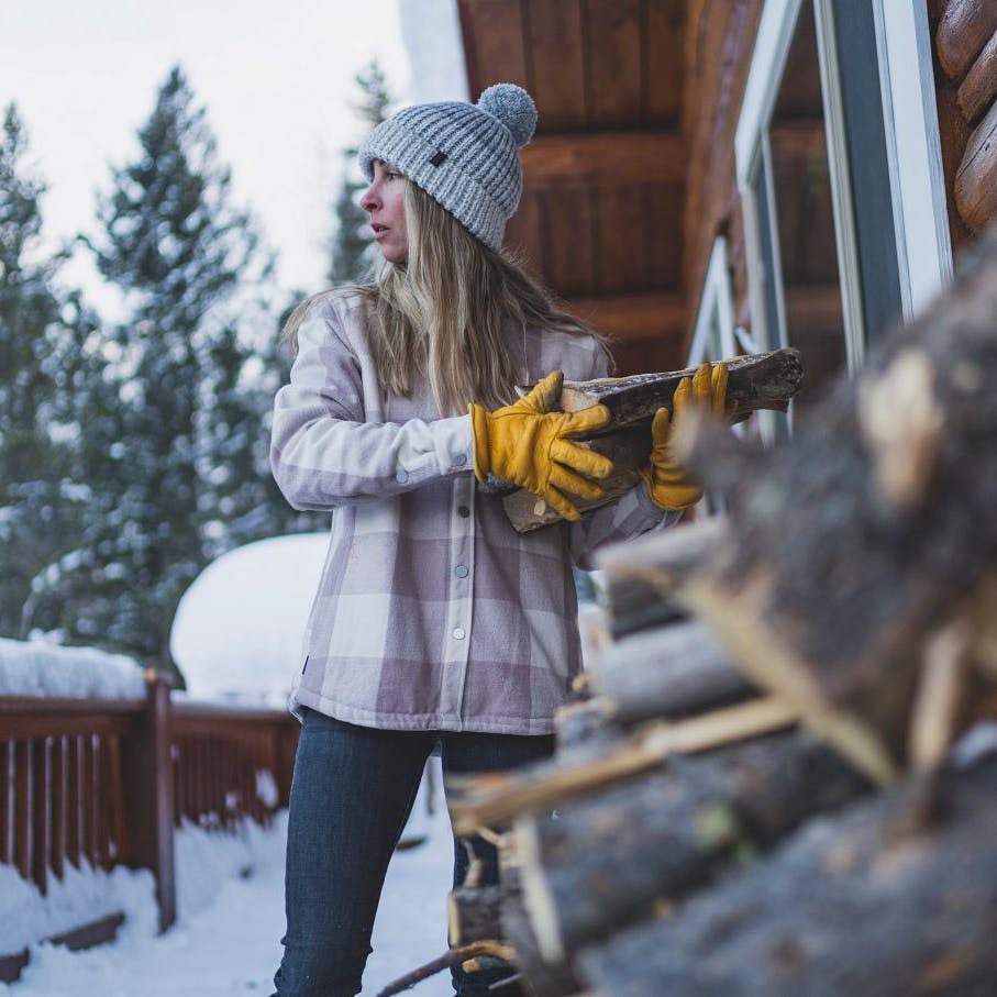 BD athlete Kelly Haplin brings wood inside her home.