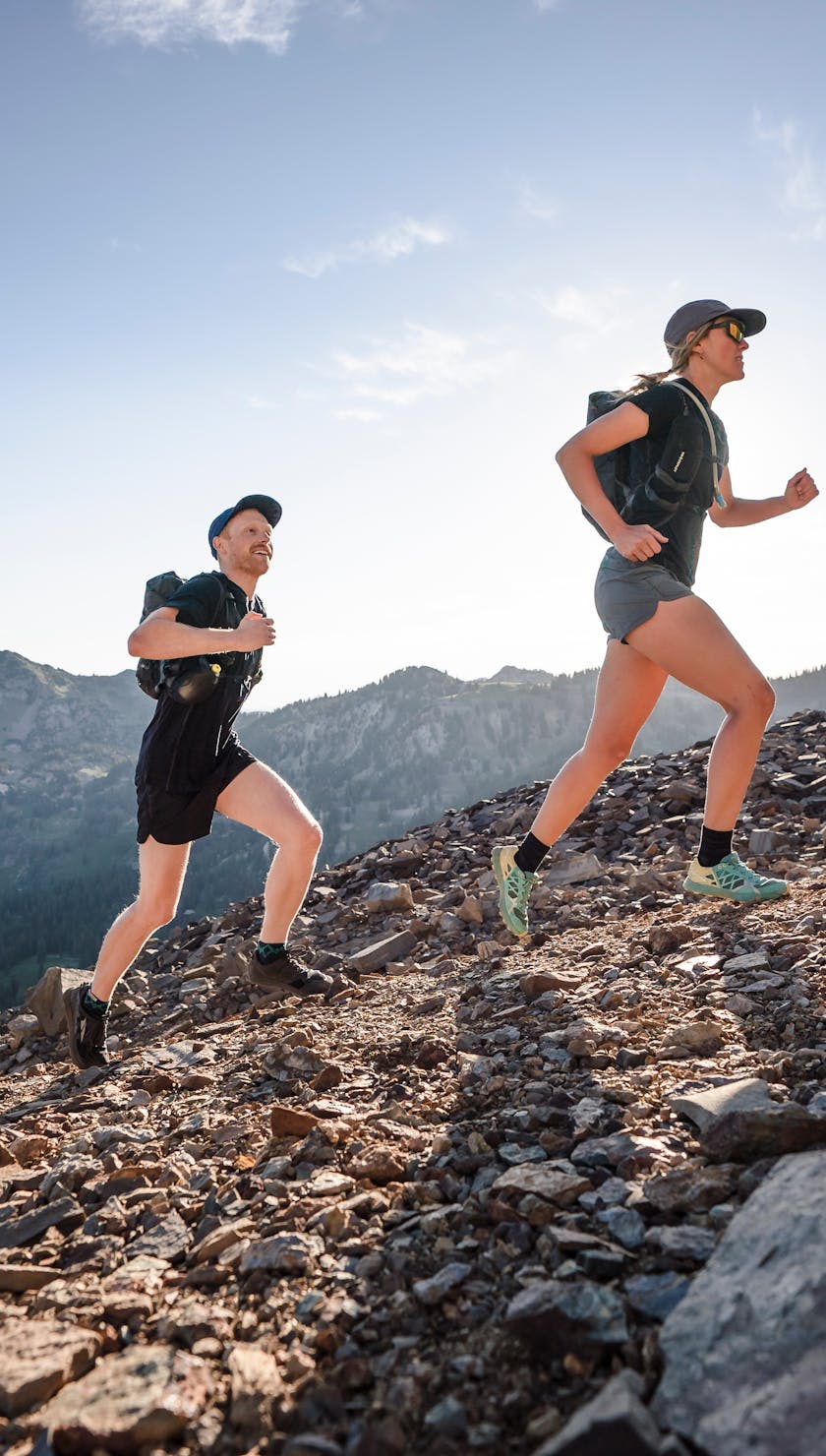 two runners going up a ridge