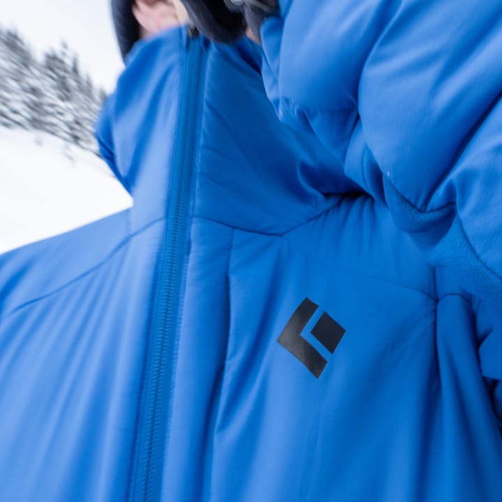 A Black Diamond Firstlight Hybrid Hoody is zipped up to keep the cold away. 