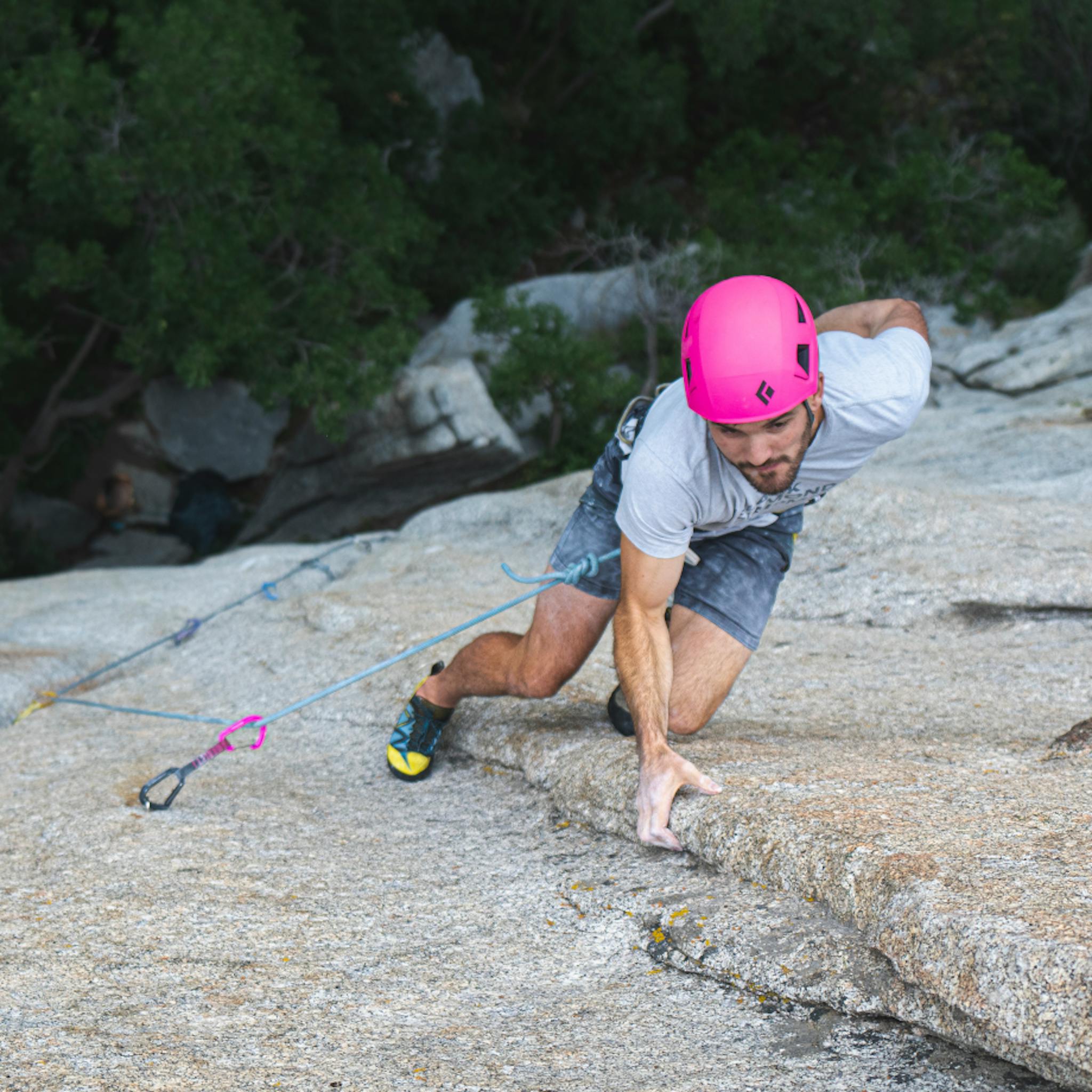 A climber chalks up midway up route wearing a Capitan Helmet.