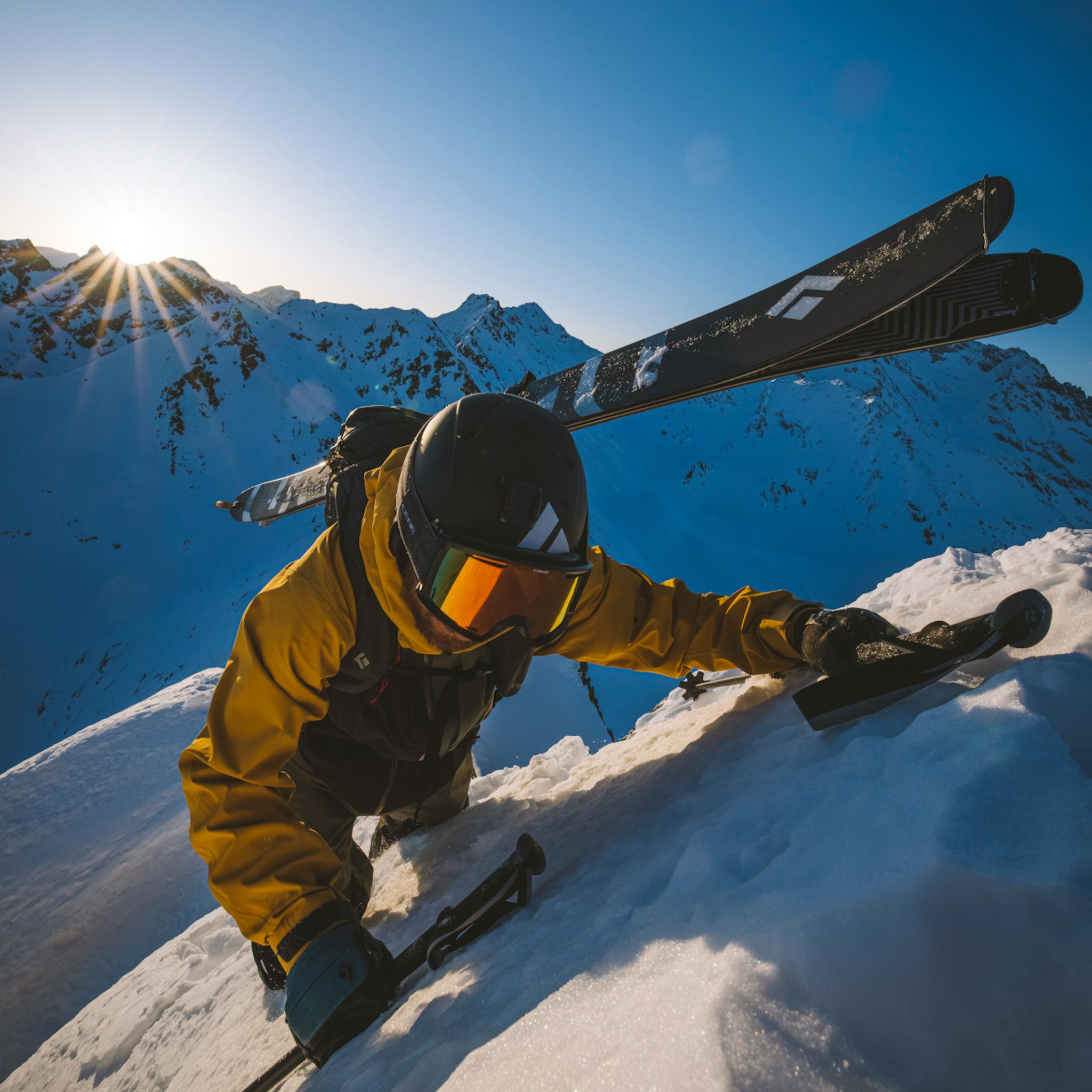 A skier approaching the peak with Impulse skis