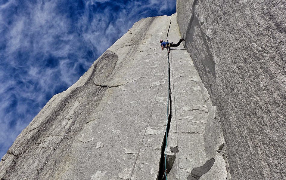 photo of climber in a crack on the wall