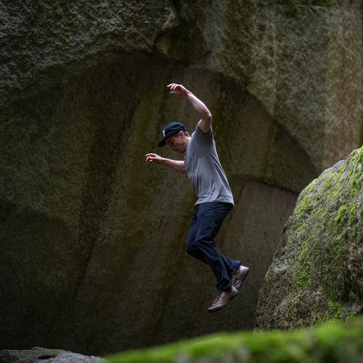 BD athlete Carlo Traversi jumps off a rock in Black Diamond apparel. 