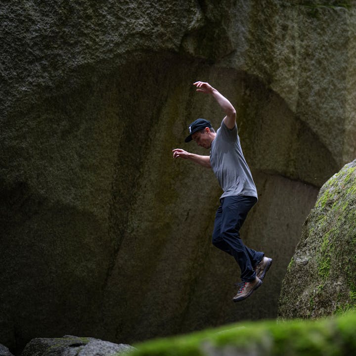 BD athlete Carlo Traversi jumps off a rock in Black Diamond apparel. 