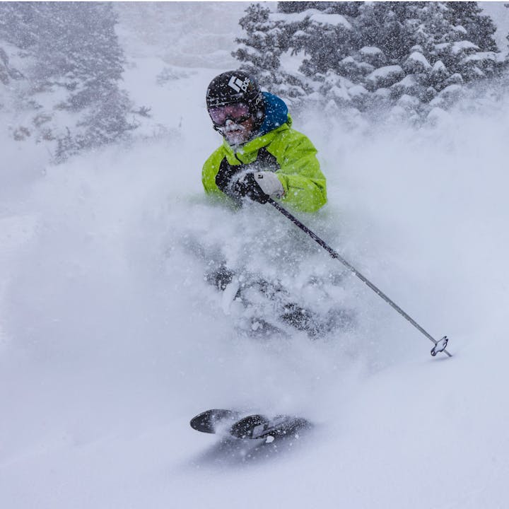 Man skiing in deep powder with Black Diamond Recon LT Jacket