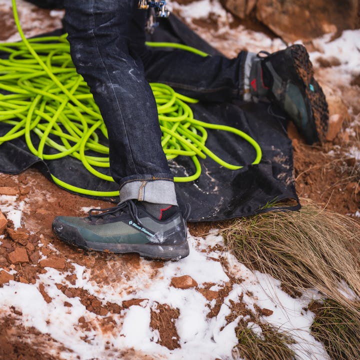 A belayer gets their Black Diamond Mission LT 2.0 Approach Shoes dirty in the desert. 