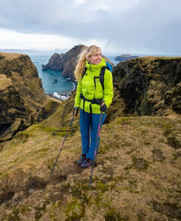 A hiker in Iceland wearing the Black Diamond Stormline stretch rain shell in the Aloe colorway.