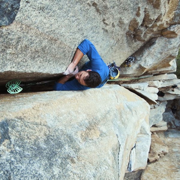 Chris climbing a wide granite crack