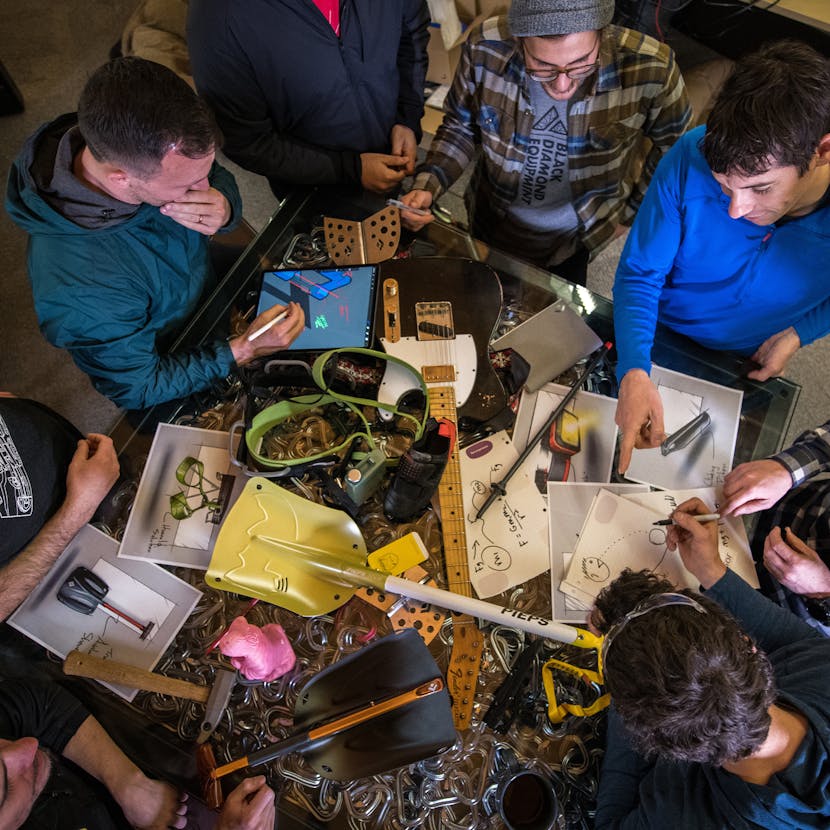 Black Diamond engineers huddled around a table