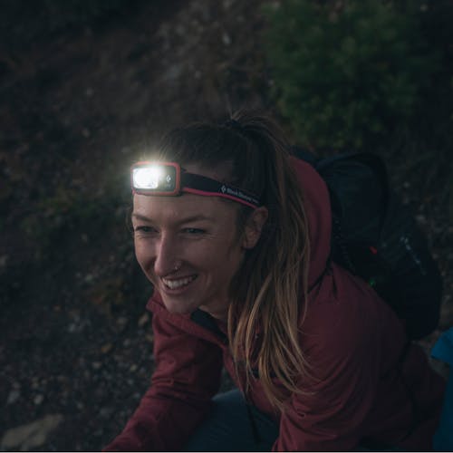 A hiker wearing the new Spot 400 Dual Fuel headlamp.