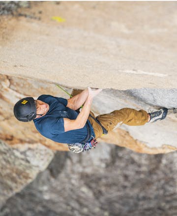 Black Diamond employee Nik Berry climbing in the Technician Pro Alpine Pants.