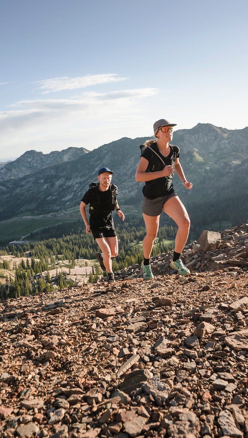 two runners going up a ridge